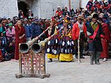 Mustang Lo Manthang Tiji Festival Day 2 15 Clown Dancers Blowing Horns Two clown dancers blew long horns near the end of the second day of the Tiji Festival in Lo Manthang. The day ended shortly after when it started to hail at 17:45, with everybody, including the Future King and his daughter, scattering quickly.